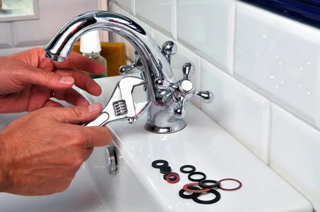 Plumber performing maintenance on a bathroom faucet in Albany