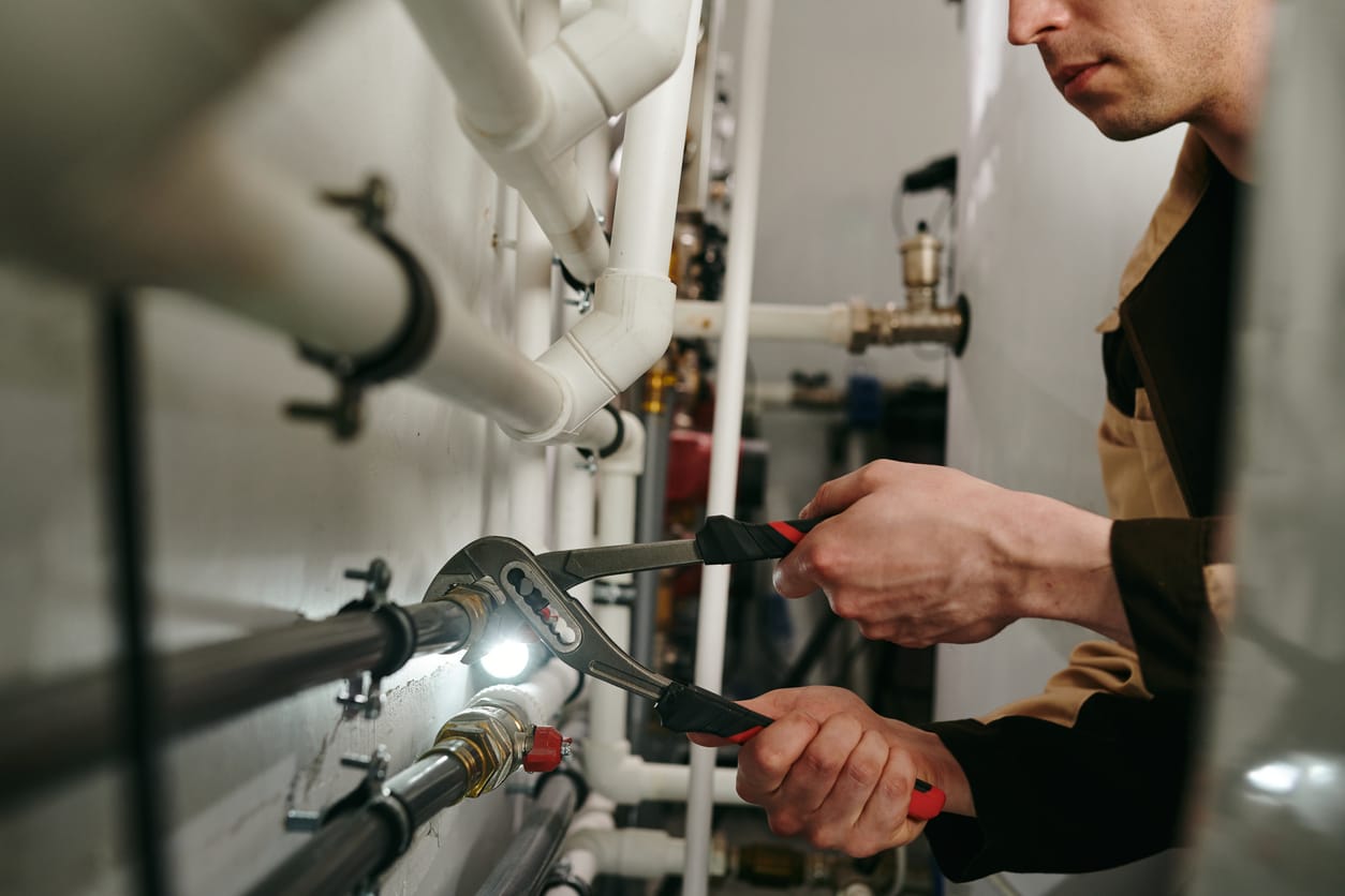 Plumbers maintaining commercial plumbing pipes in Albany